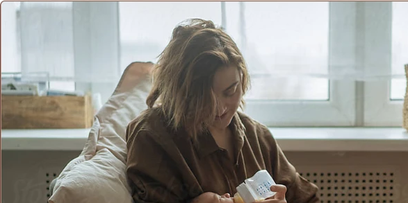 A mother feeding her baby a bottle of pumped breast milk